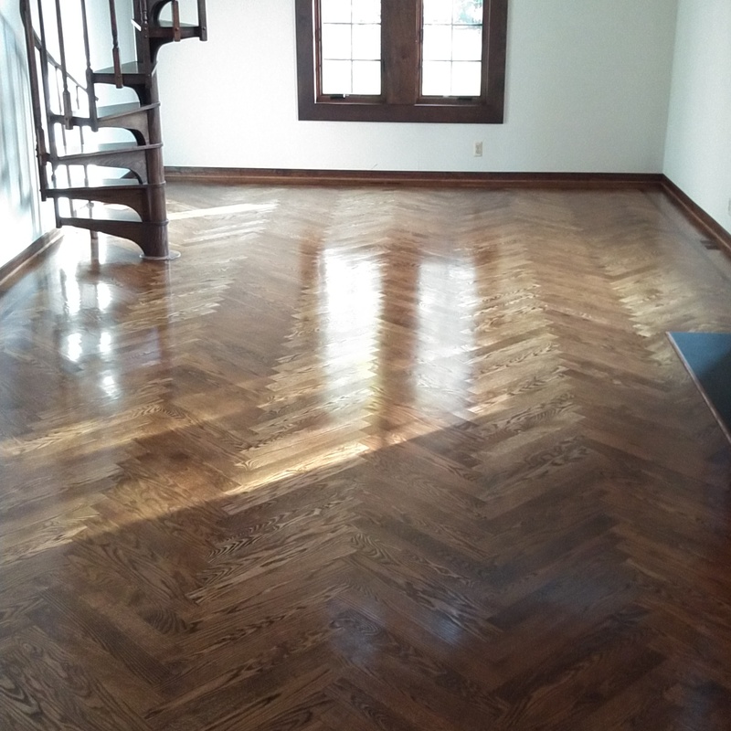 Herringbone in a 3"x21" pattern with a 1" Walnut feature strip and two board border.