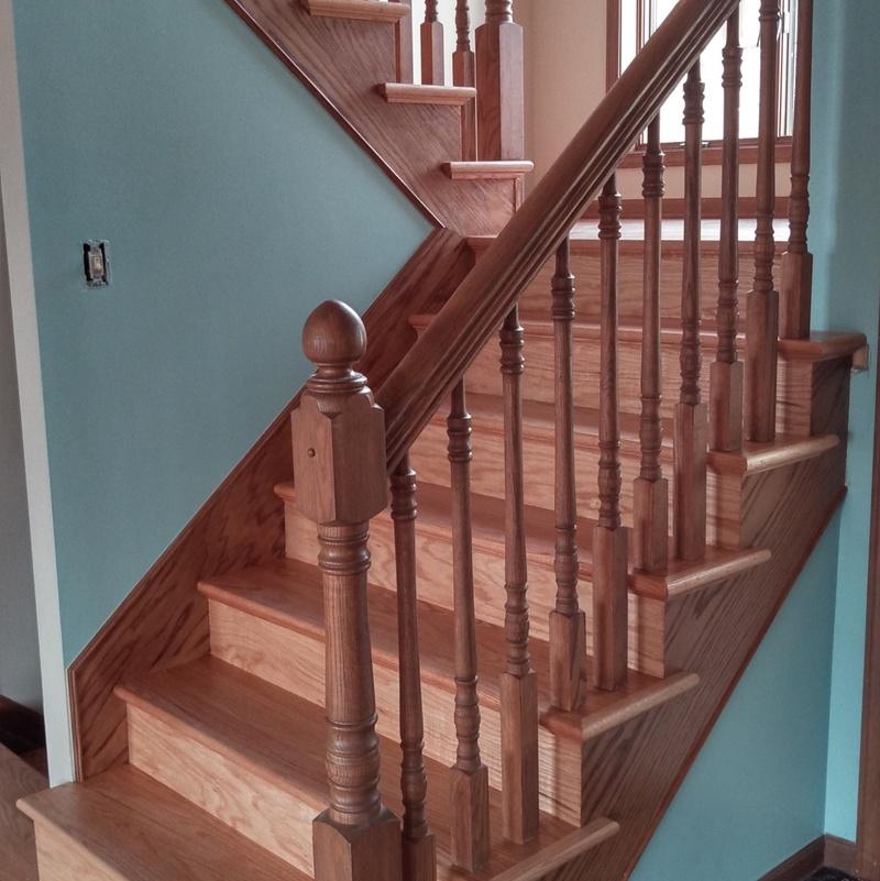 Custom Red Oak stair treads with mitered risers and matching skirt boards.