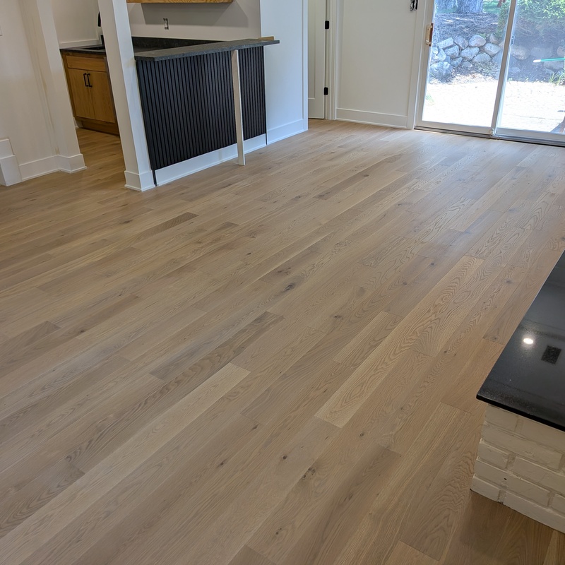 4 Inch engineered prefinished White Oak direct glue over concrete in residential lower level.